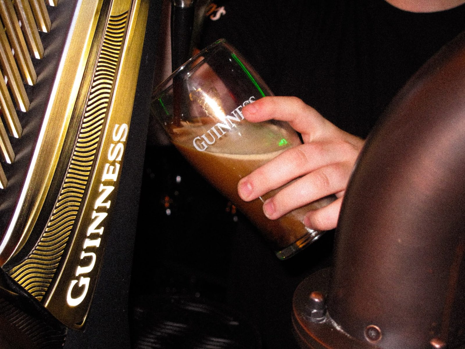 A creamy stout pint settling under warm light